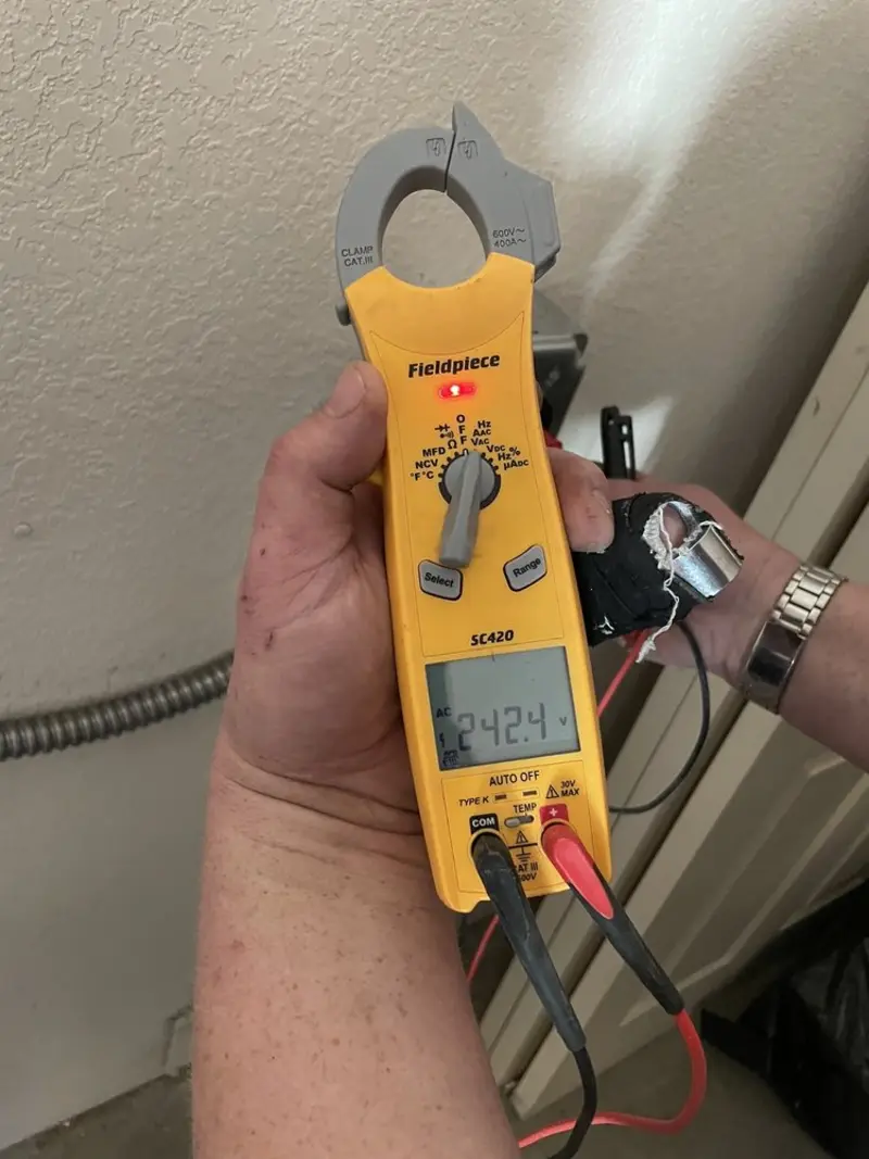 Voltage testing with clamp meter during Electrical Installation Services in Romulus